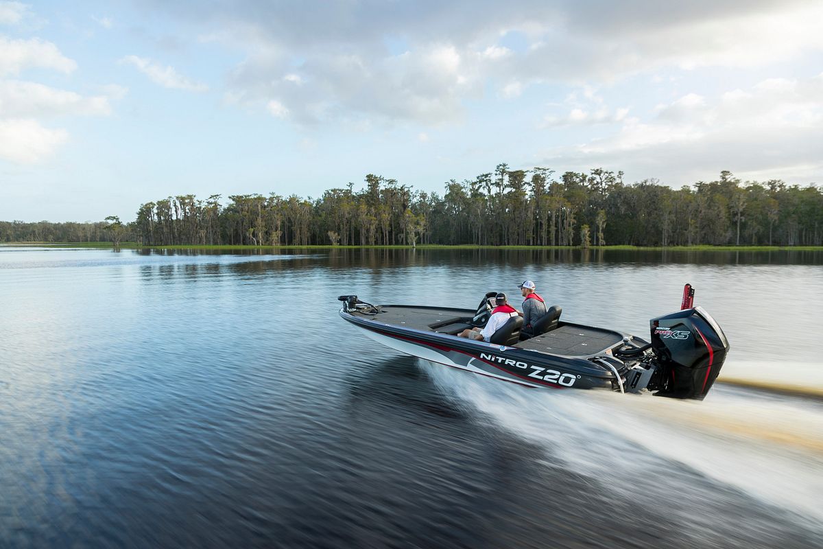 Two people cruising on a boat powered by a Mercury Marine engine equipped with Mercury Boost