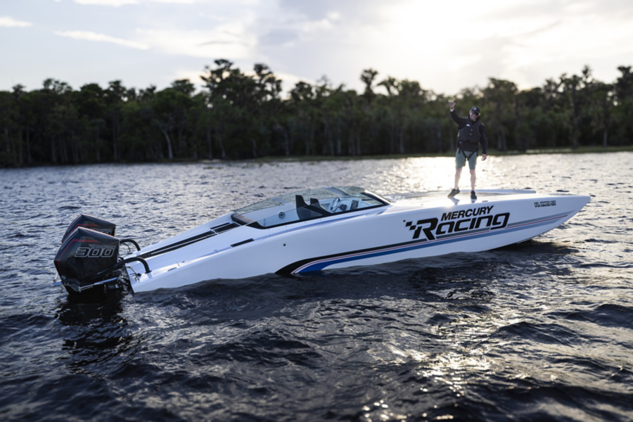 travis pastrana standing on mercury racing boat with twin 300r engines