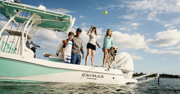 A family on a boat with a dog with Mercury Marine 1st Mate wrist bands