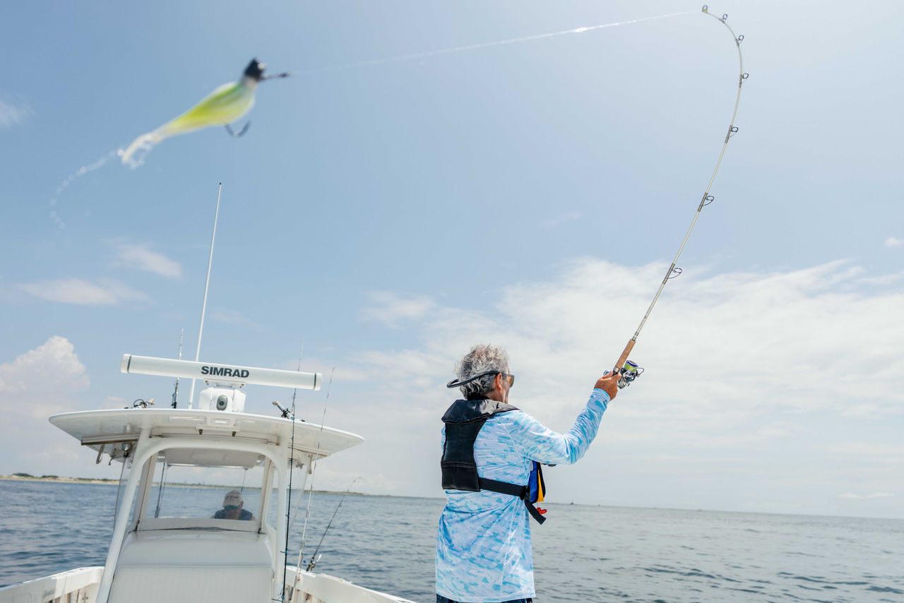 an angler casts a line on an offshore fishing trip