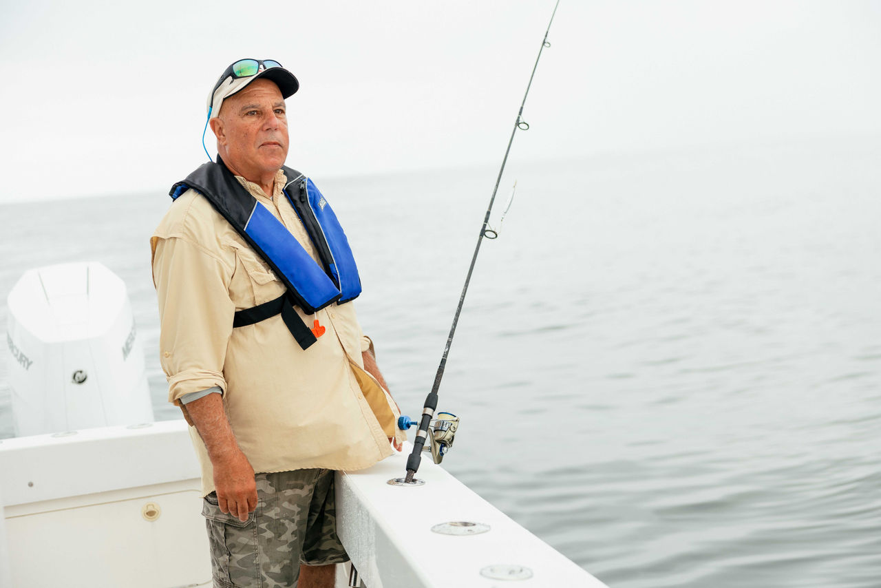 a captain standing on his boat with twin Mercury V10 Verado outboard engines