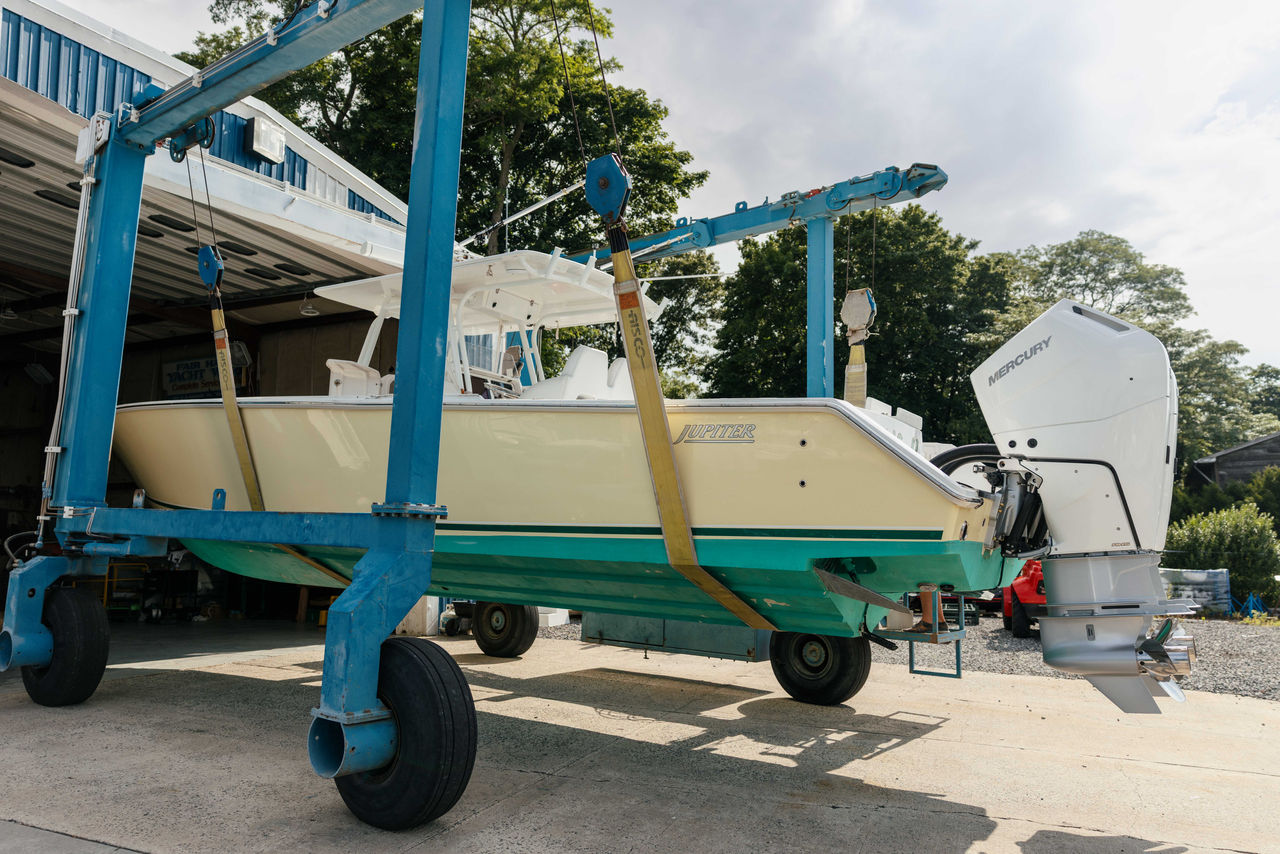A Jupiter boat with Mercury V10 Verado outboard engines being carried on a lift