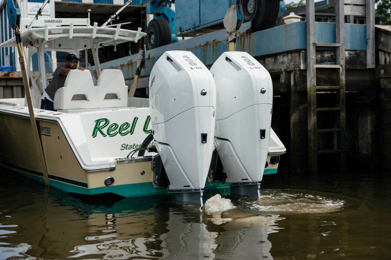 A Jupiter boat with Mercury V10 Verado outboard engines being placed in the water
