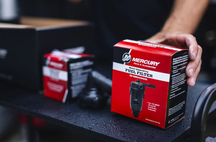 Hand holding Mercury Marine part