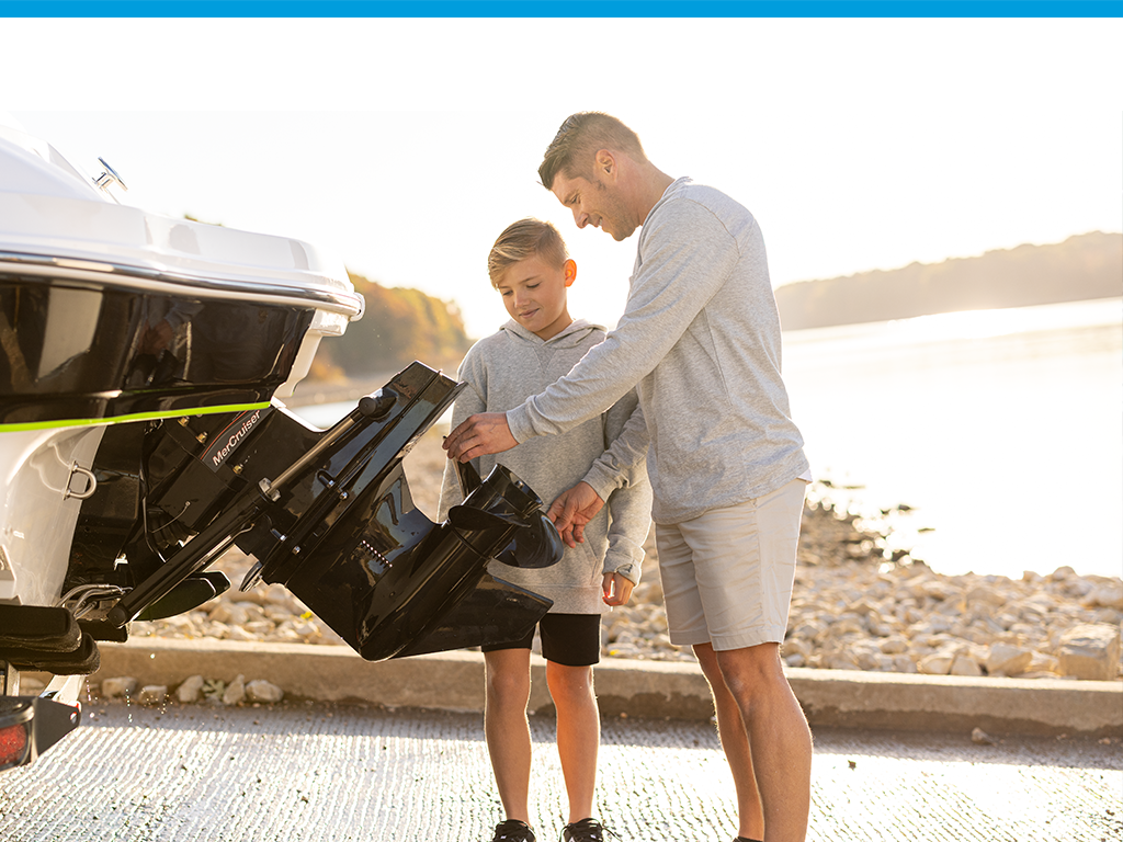 father and son changing boat prop