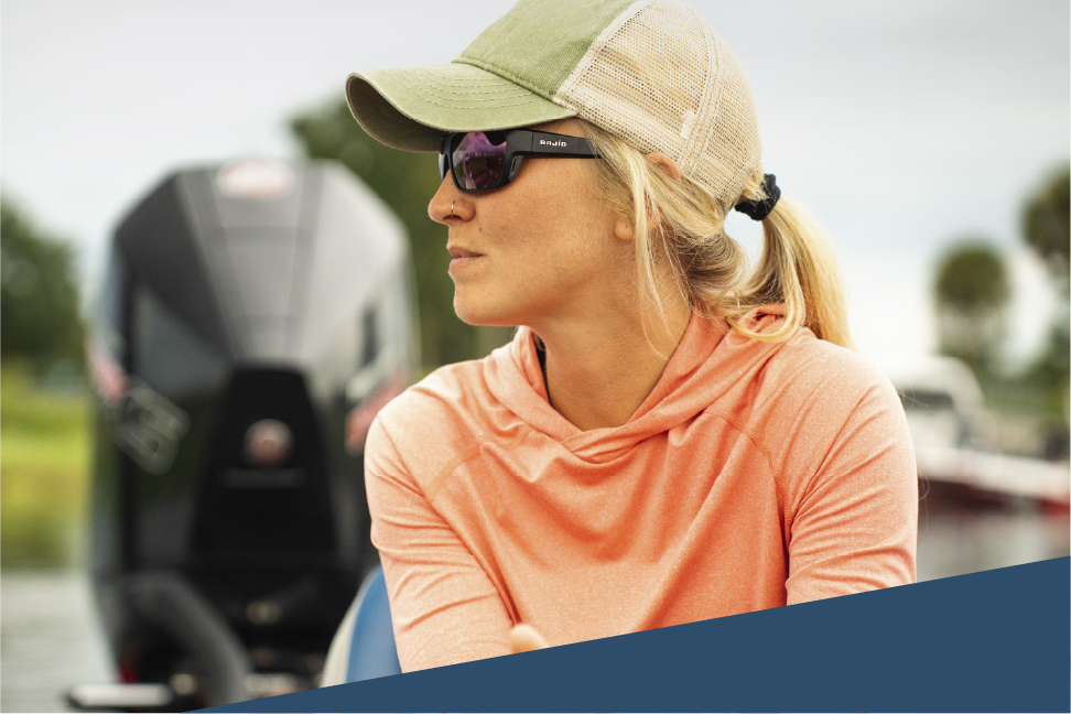 Woman in boat wearing hat and sunglasses